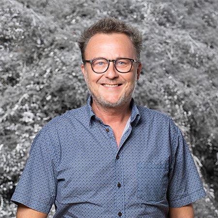 Thomas-Due-HJHansen-Recycling Portræt billede af Thomas Due der er produktchef hos HJHansen Recycling. Han er iført blå kortærmede skjorte og briller.